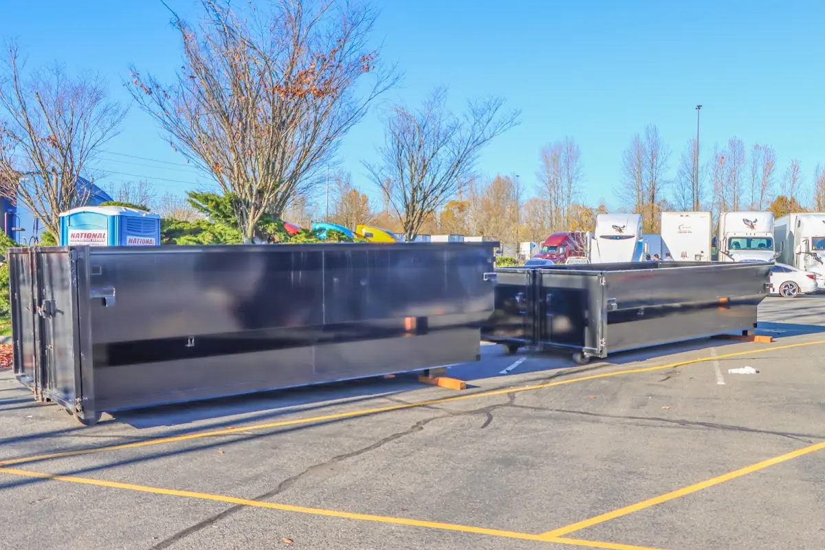 Professional dumpster rental service with roll-off container on residential driveway in Wesley Chapel